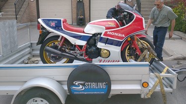 David Booth beguns unloading his Honda motorcycle from Charles Snell's trailer