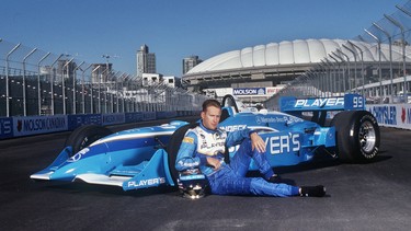 Hometown hero Greg Moore strikes a pose with his Indy car on the home straight at Vancouver's then-new Indy track in 1998.