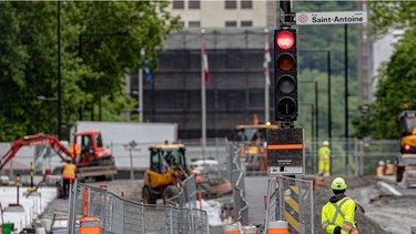 A construction worker surveys the construction on Peel St. between St-Antoine St. and René-Lévesque Blvd. in Montreal on Tuesday June 1, 2021.