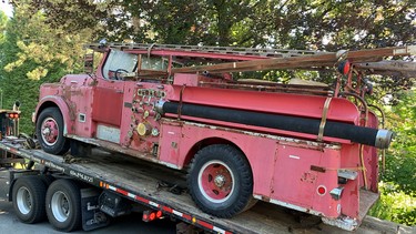The 1954 Thibault pumper No. 13 gets unloaded for what will be a long, and for the volunteers probably very enjoyable, restoration.
