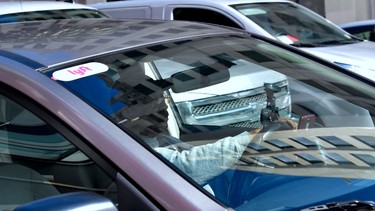 A driver with the Lyft decal on his vehicle cruises Hollywood, California on February 21, 2019.