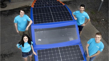 Polytechnique Montréal students, Marie-Claude Normand, left to right, Henri Larocque, Frederic Melanson and Anthony Riendeau with the solar car they built and will drive to the Gaspé region, seen in Montreal, on Tuesday, July 27, 2021.