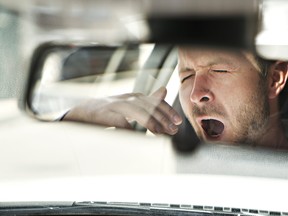 fatigue A man yawn in his car because is so tired
