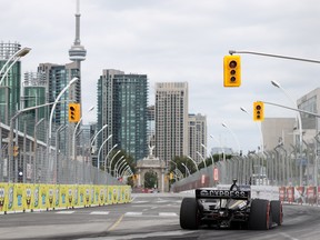 James Hinchcliffe speeds by the Toronto cityscape.