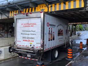 Toronto truck stuck under bridge