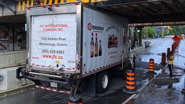 Toronto truck stuck under bridge