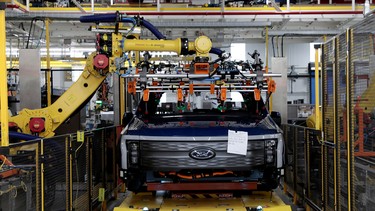 A robot works on a Ford pre-production all-electric F-150 Lightning truck prototype at the Rouge Electric Vehicle Center in Dearborn, Michigan, U.S. September 16, 2021.