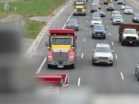 A convoy of over 1,000 dump trucks moves east in the express lanes of the 401 at Toronto's Avenue Rd. as part of a protest staged by the Ontario Dump Truck Association on Thursday, April 15 2021.