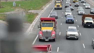 A convoy of over 1,000 dump trucks moves east in the express lanes of the 401 at Toronto's Avenue Rd. as part of a protest staged by the Ontario Dump Truck Association on Thursday, April 15 2021.
