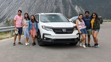 Nitin Garg (middle right) of Toronto picked up this 2021 Honda Pilot Black Edition with his wife Tanvi Kalra (leaning against driver side front fender) and four other family members and drove as far as Hinton, Alberta in the seven-passenger SUV. There was plenty of room for all passengers and luggage, which impressed Garg.