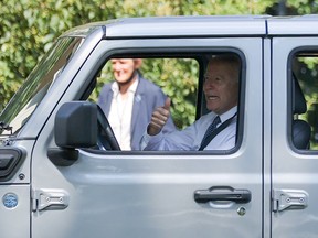 U.S. President Joe Biden gives a thumbs-up to guests while driving a Jeep Rubicon 4xe at an event for clean cars and trucks, and signs an executive order on transforming the country’s auto fleet at the White House in Washington, U.S. August 5, 2021.