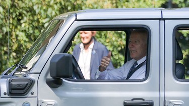U.S. President Joe Biden gives a thumbs-up to guests while driving a Jeep Rubicon 4xe at an event for clean cars and trucks, and signs an executive order on transforming the country’s auto fleet at the White House in Washington, U.S. August 5, 2021.