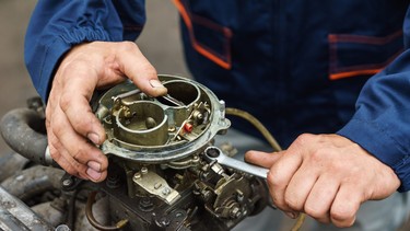 Mechanic servicing a carburetor
