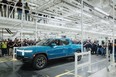 The first production Rivian R1T electric pickup rolling off the assembly line