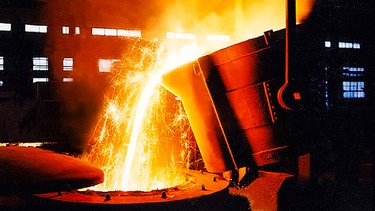 A large bowl of molten metal at a steel mill.