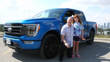 Tester Ted Pietryka and his daughter Ava are seen with the 2021 Ford F-150.