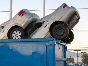 Two scrap cars in a bin