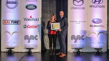 Lorraine Sommerfeld accepting the 2021 AJAC Journalist of the Year award from Jaguar's John Lindo