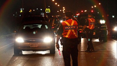 Police officers stop drivers near Windsor Raceway on August 14, 2010 during a RIDE program in Windsor, Ont.