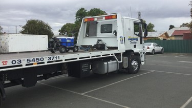 An "Esky" motorized cooler on a flatbed tow truck