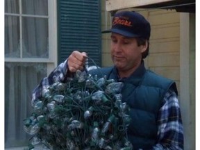 Clark Griswold (Chevy Chase) grabs a mess of Christmas lights in the movie National Lampoon's Christmas Vacation.