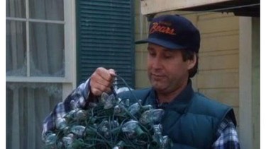 Clark Griswold (Chevy Chase) grabs a mess of Christmas lights in the movie National Lampoon's Christmas Vacation.