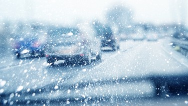 A snowy road congested with traffic.