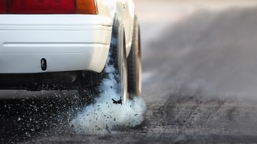 Drag racing car warms its tires in preparation for a race