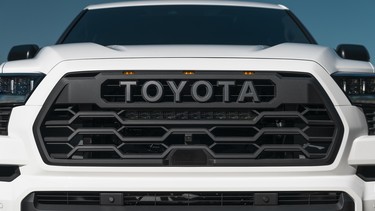 The 'Toyota' logo in the grille badge of a 2023 Toyota Sequoia TRD Pro