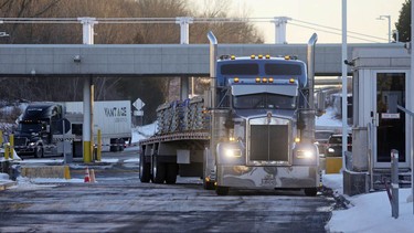 Trucks head into Canada from the U.S. at the Highgate Springs-St.Armand/Philipsburg Border Crossing in Saint-Armand, Quebec, Canada, on Friday, Jan. 14, 2021. A group of Canadian truckers are organizing a convoy to drive to Ottawa, from as far as B.C., to protest the federal vaccine mandate.