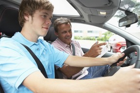 Teenager taking a driving lesson with instructor