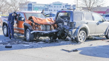 Peel Regional police investigate the scene of a three-vehicle crash on Queen St. east of Torbram Rd. in Brampton, Ontario that sent two people to hospital with non-life threatening injuries on Thursday January 22, 2015.