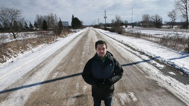 Kingsville Mayor Nelson Santos stands near a section of Highway 3 at Division Road where the Province of Ontario is expropriating land for the long-awaited widening of Highway 3. Photographed Jan. 28, 2022.