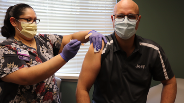 Mark Kreusel, plant manager at Stellantis NV's Belvidere Assembly Plant in Illinois, receives the COVID-19 vaccine at the company's health and wellness center.