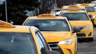 A lineup of Checker Cabs along Palmer Rd. NE. Thursday, February 17, 2022.