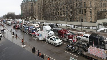 Anti-vaccine mandate protesters and truckers protesting their sixth day on Wellington Street in downtown Ottawa Wednesday.