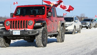 A convoy protesting COVID-19 mandates leaves a truck stop and heads towards Highway 402 on Sunday, Feb. 6, 2022 in Plympton-Wyoming, Ont.