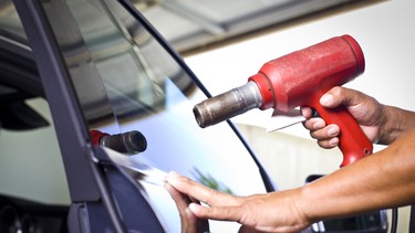 Technician heating window tint