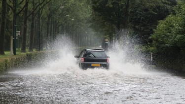 Car driving along a flooded street