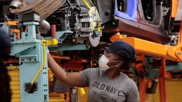 A Stellantis assembly worker works on assembling the 2021 Jeep Grand Cherokee L at the Detroit Assembly Complex in the Mack Plant in Detroit, Michigan, U.S., June 10, 2021.