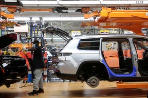 A Stellantis assembly worker works on a 2021 Jeep Grand Cherokee L at the Detroit Assembly Complex in the Mack Plant in Detroit, Michigan, U.S., June 10, 2021.