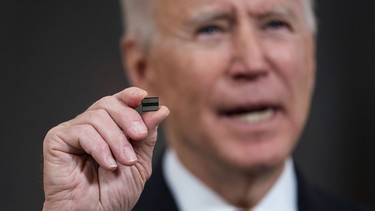U.S. President Joe Biden holds a semiconductor during his remarks before signing an Executive Order on the economy in the State Dining Room of the White House on February 24, 2021 in Washington, DC.