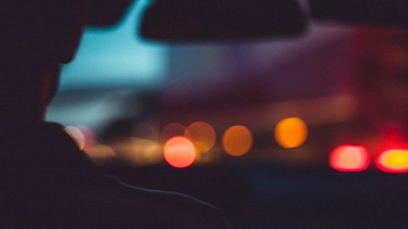 Silhouette of a driver in the dark at night