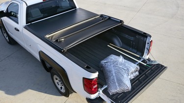 A 2017 Chevrolet Silverado wearing a tri-fold tonneau cover