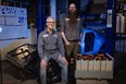David Lloyd and Jason Arnold of Calgary's EV Underground pose in their "bat cave of a shop."