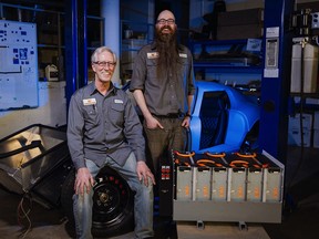 David Lloyd and Jason Arnold of Calgary's EV Underground pose in their "bat cave of a shop."