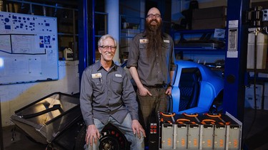 David Lloyd and Jason Arnold of Calgary's EV Underground pose in their "bat cave of a shop."