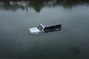 Ford Bronco stuck in a sandbar, flooded by the ocean for several days