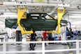 Employees work on an assembly line at startup Rivian Automotive's electric vehicle factory in Normal, Illinois, U.S. April 11, 2022.