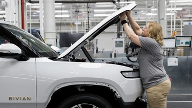 An employee works on an assembly line at startup Rivian Automotive's electric vehicle factory in Normal, Illinois, U.S. April 11, 2022.